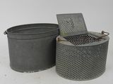 two metal trash cans sitting next to each other on a white surface