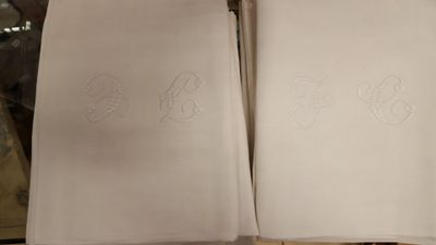 deux serviettes ornées de monogrammes posées sur une table