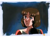 an image of a woman with brown hair and blue eyes in front of a blue background