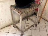 a black hat sitting on top of a table in a dirty room