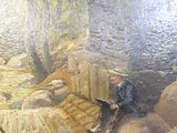 un tableau représentant un homme assis sur un banc en train de lire un livre