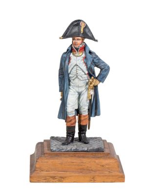 statue of a man in a blue coat and hat standing on a wooden base