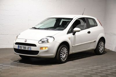 une petite voiture blanche garée dans un garage