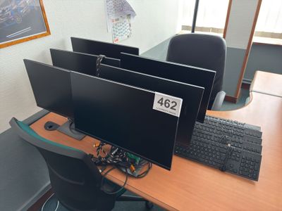 three computer monitors sitting on a desk with a keyboard and mouse