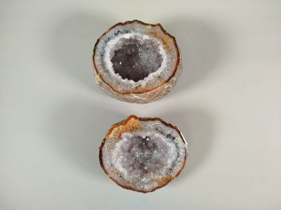 three pieces of geoglyite sitting on top of a white surface