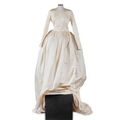 an image of a dress on a mannequin stand on a white background