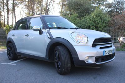 a picture of a white mini cooper parked in a parking lot