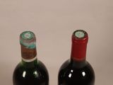 two bottles of wine sitting next to each other on a table