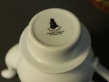 a white vase with a black design on it