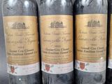 four bottles of wine are lined up on a table