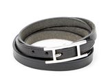 black leather bracelet with a silver buckle on a white background