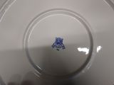 a white plate with a blue design on it