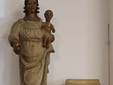 une statue de femme tenant un enfant sur une table