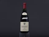 a bottle of wine sitting on top of a black table