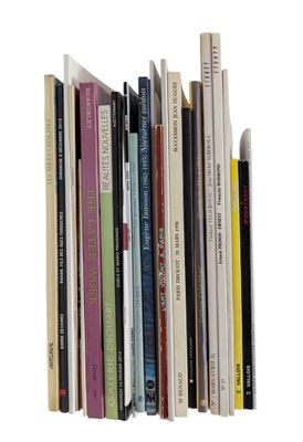 a lot of books that are stacked together on a shelf