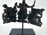 an image of a metal sculpture of a group of people on horseback