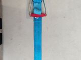 a blue strap with a red buckle hanging on a wall