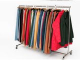 three racks with clothes on them and a rack with clothes on it