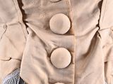 a close up of a woman ' s jacket with buttons