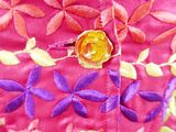 close up of a pink jacket with colorful flowers on it