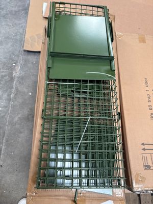 a bird cage that is sitting on top of a cardboard box