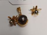 a close up of a pair of earrings sitting on top of a table