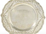 a silver plate on a stand on a white background