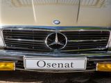 a close up of the front of a car with the name osenat on it