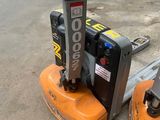 a picture of a forklift sitting in a parking lot