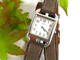 a watch that is sitting on top of a brown strap