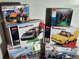 four boxes of legos on the floor next to each other