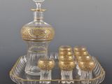 an antique glass decanter set with six glasses and a decanter on a tray