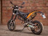 a motorcycle that is parked in front of a brick wall