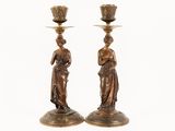 pair of antique bronze candlesticks with female figures on them