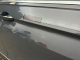 a close up of a car door handle with a sticker on it
