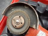 a red tool box with a red grinder on top of it