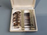 a box with a bunch of silver spoons inside of it
