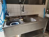 a kitchen with a sink and a washing machine in it