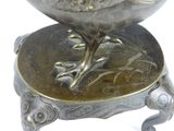 a silver bowl with a bird on it on a stand