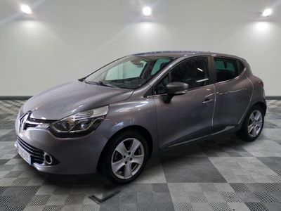 the grey car is parked on a checkered floor in the garage