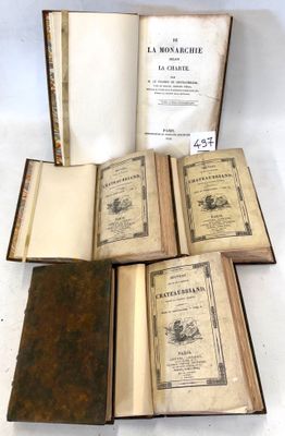 several old books sitting on top of each other on a table