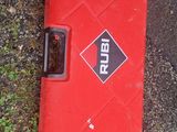 a red case sitting on the ground next to the grass