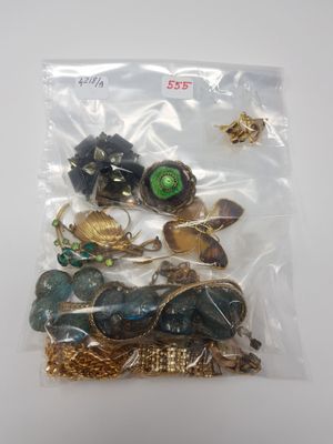 a bag of assorted jewelry sitting on a table