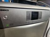 the front panel of a dishwasher that is sitting on top of a washer