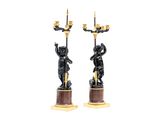 pair of black and gold candlesticks with cher chers