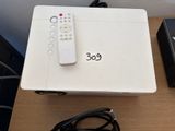 a remote control sitting on top of a white box