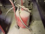 a fire extinguisor sitting on the floor next to a sink