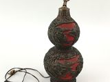 a lamp that is sitting on a table next to a cord