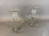 two clear glass vases sitting on top of each other