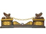 une horloge dorée et noire sur laquelle figurent deux oiseaux